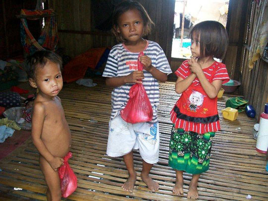 Bajai children delight in treats given them.