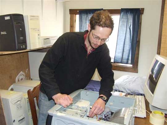 Jim fixing AHAN donated computers.