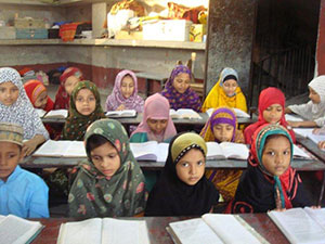 Girls in primary grades studying in their classroom