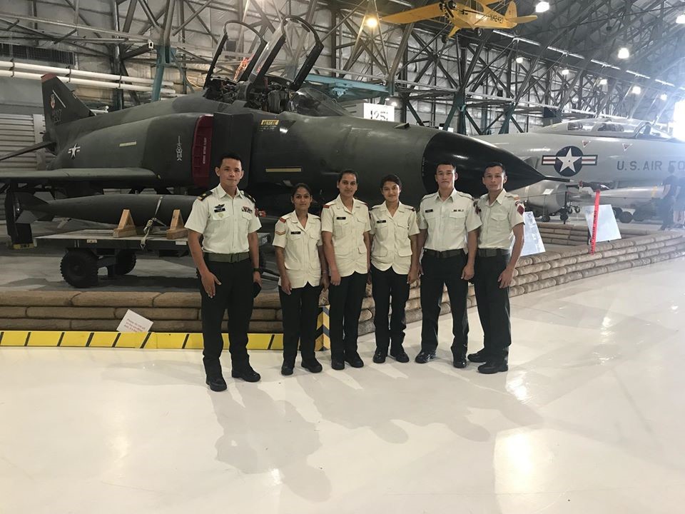 A Group of Men in Uniform in Front of a Jet