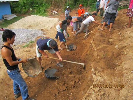 Excavating the land by hand with other Karen refugee volunteers